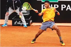  ?? ASSOCIATED PRES FILE PHOTO ?? Canada’s Felix Auger-Aliassime returns May 13 against Croatia’s Borna Coric at the Italian Open in Rome. Auger-Aliassime has risen to No. 28 in the world rankings and is aiming for a strong French Open.