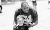  ?? CHRIS HAYS / STAFF ?? Green Bay Packers safety Ha Ha Clinton-Dix, formerly of Dr. Phillips High, poses with a child at an Orlando camp.