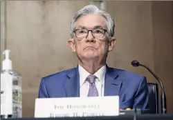  ?? Susan Walsh / Associated Press ?? Chairman of the Federal Reserve Jerome Powell, seen here in December appearing before the Senate Banking Committee on Capitol Hill in Washington, said the U.S. economy is improving, but the recovery from the impact of the pandemic is far from complete.