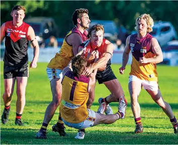  ?? Photograph­s by CRAIG JOHNSON. ?? Warragul’s Tom Hobbs attempts to fend off the tackle of Drouin’s Aden Quirk late in the fourth quarter.