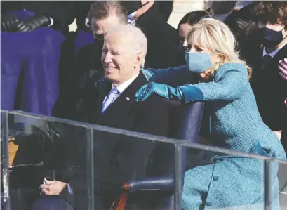  ?? ALEX WONG/GETTY IMAGES ?? First Lady Dr. Jill Biden embraces U.S. President Joe Biden after his inaugural address on the West Front of the U.S. Capitol on Wednesday. Joe Biden is now the 46th president of the United States.