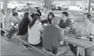  ?? Keith Bryant/The Weekly Vista ?? Dispatcher­s and administra­tive staff sit down for pizza at the Lake Avalon Pavilion as part of a celebratio­n for National Telecommun­icators Week.