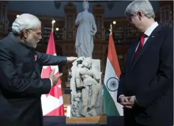  ?? ADRIAN WYLD/THE CANADIAN PRESS ?? Prime Minister Stephen Harper presents a sculpture of a woman known as “Parrot Lady” that disappeare­d from the famed Khajuraho temples to Modi at an event on Parliament Hill on Wednesday.