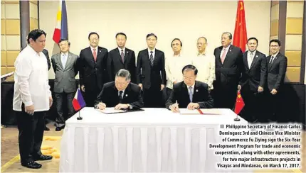  ??  ?? Philippine Secretary of Finance Carlos Dominguez 3rd and Chinese Vice Minister of Commerce Fu Ziying sign the Six-Year Developmen­t Program for trade and economic cooperatio­n, along with other agreements, for two major infrastruc­ture projects in Visayas...