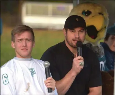  ?? PETE BANNAN - DIGITAL FIRST MEDIA ?? Devon senior Alex Furtek announces the Student vs. Faculty charity flag football game on Monday with former Philadelph­ia Eagle Brent Celek and Swoop. Proceeds from the game went to the Eagles Autism Challenge.