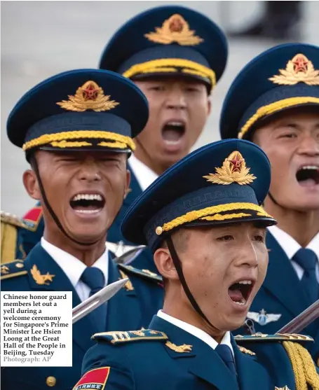  ?? Photograph: AP ?? Chinese honor guard members let out a yell during a welcome ceremony for Singapore's Prime Minister Lee Hsien Loong at the Great Hall of the People in Beijing, Tuesday