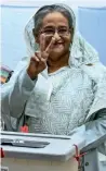  ?? AFP ?? Hasina flashes the victory symbol after casting her vote at a polling booth in Dhaka. —