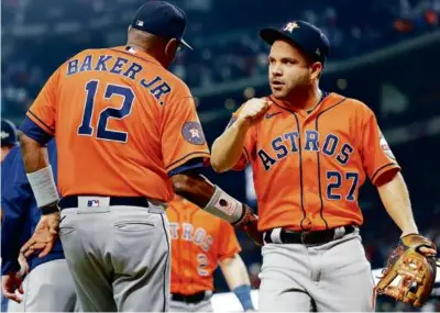  ?? CARMEN MANDATO/GETTY IMAGES ?? Manager Dusty Baker, Jose Altuve, and the Astros cut the Rangers’ series lead in half.