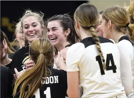  ?? BILL UHRICH — READING EAGLE ?? Berks Catholic’s Caraline Herb, center, facing camera, is mobbed by teammates after scoring her 1,000th career point Friday.