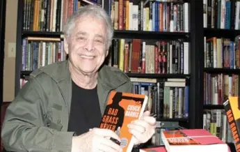  ?? GIULIO MARCOCCHI/GETTY IMAGES FILE PHOTO ?? Chuck Barris signs copies of Bad Grass Never Dies in 2004 in West Hollywood, Calif. He died Tuesday at 87.