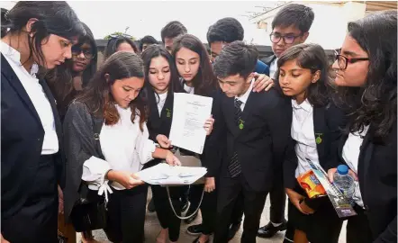  ??  ?? Better protection: Sayfol Internatio­nal School Ampang students looking at a printout of the Sexual Offences Against Children Bill 2017 that was tabled in Parliament. — RAJA FAISAL HISHAN/ The Star