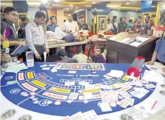  ?? AFP ?? A mobile court of Rapid Action Battalion (RAB) personnel, the elite anti-crime unit of Bangladesh Police, detain casino staff and gamblers in September in Dhaka.