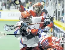  ?? CLIFFORD SKARSTEDT/EXAMINER FILES ?? Peterborou­gh Lakers' Shawn Evans, left, checks New Westminste­r Salmonbell­ies' Ian Hawksbee into the boards during Mann Cup championsh­ip action at the Memorial Centre on Sept. 14, 2010. Evans and Mark Steenhuis will be the only returning Lakers when the...