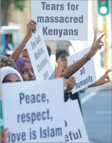  ?? Picture: BRENTON GEACH ?? IN SOLIDARITY: A group of Muslims gathered outside St George’s Cathedral yesterday holding placards in support of Christian families who lost loved ones in recent attacks by Boko Haram and al-Shabaab.