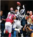  ?? CURTIS COMPTON / CCOMPTON@AJC.COM ?? Rams running back Todd Gurley gets past Falcons linebacker Vic Beasley for a touchdown reception in the first quarter Sunday.