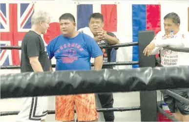  ??  ?? SO WHO’S THE BOSS? — Chief trainer Buboy Fernandez, 2nd from left, appears to be clearing some things up with Hall of Famer Freddie Roach, left, during Manny Pacquiao’s workout on Christmas Day at Roach’s Wild Card gym in Los Angeles, California. (Sean Gibbons)