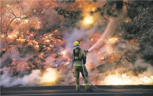  ?? Justin Sullivan / Getty Images 2013 ?? California wildfires, such as the August 2013 blaze near Groveland (Tuolumne County), release a huge amount of carbon dioxide into the air.