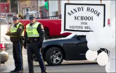  ??  ?? File photo shows police stand guard at the entrance to the Sandy Hook School in Newtown, Connecticu­t. — AFP photo