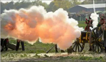  ?? AP PHOTO/JENS MEYER ?? Troops fight during the reconstruc­tion of the Battle of the Nations at the 205th anniversar­y near Leipzig, Germany, Saturday. The Battle of Leipzig or Battle of the Nations, on 16–19 October 1813, was fought by the coalition armies of Russia, Prussia, Austria and Sweden against the French army of Napoleon. The battle decided that Napoleon had to retreat to France, the beginning of his downfall.