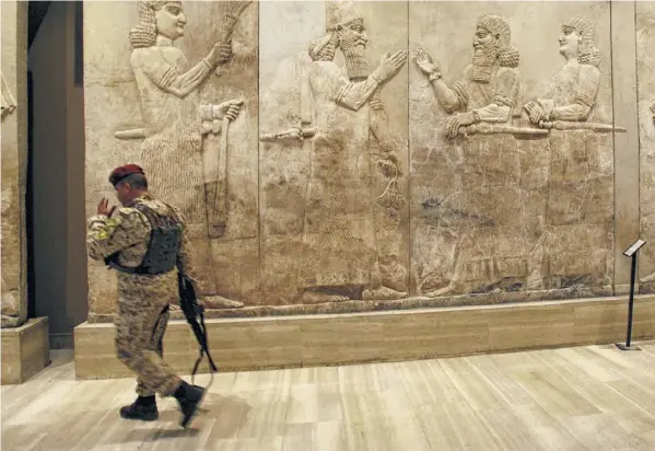  ??  ?? An Iraqi soldier stands guard in the restored Iraqi National Museum on the day it was formally dedicated in Baghdad in 2009, nearly six years after looters carried away priceless antiquitie­s and treasures in the chaos following the U.s.led invasion. The Army has announced it has created a unit similar to the Monuments Men of World War II fame that will guide fighting units in protecting the cultural heritage of areas of combat operations.