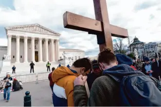  ?? Jose Luis Magana/Associated Press ?? Antiaborti­on activists pray outside the U.S. Supreme Court on Friday. An investigat­ion failed to determine who leaked a draft of the opinion last year that overturned the right to abortion.