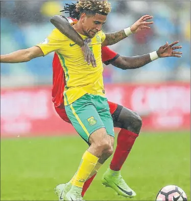  ?? Picture: GALLO IMAGES ?? MAN OF THE MATCH: South Africa’s Keagan Dolly is manhandled during their internatio­nal friendly against Guinea-Bissau at the Moses Mabhida Stadium in Durban at the weekend