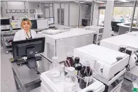  ??  ?? Lab Supervisor Taran Kaur works with a liquid chromatogr­aphy-mass spectromet­ry system at the Southwest Labs new headquarte­rs in the North I-25 area. The building, a former charter school, received top-to-bottom tenant upgrades.