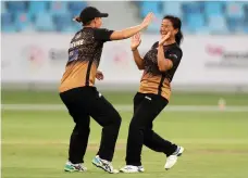  ?? Chris Whiteoak / The National ?? Tornadoes’ Sita Rana, right, celebrates the wicket of Sapphires’s Gaby Lewis in Dubai