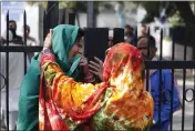  ?? MANISH SWARUP — THE ASSOCIATED PRESS ?? A woman cries outside a mortuary as she waits to receive the body of a relative who died in Sunday’s fire in New Delhi, India, on Monday.