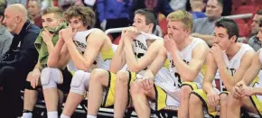  ?? RICK WOOD / MILWAUKEE JOURNAL SENTINEL ?? East Troy players show their disappoint­ment after a loss in a WIAA Division 3 state semifinal Thursday. Browse more state tournament pictures at jsonline.com/photos.
