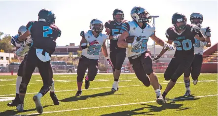  ?? PHOTOS BY JUAN ANTONIO LABRECHE/FOR THE NEW MEXICAN ?? Capital running back Luke Padilla, a freshman, scrambled for 156 yards on Saturday in the 18-13 win over Del Norte in Albuquerqu­e. Capital (3-4, 1-0) moved into sole possession of first place in the 2-5A standings.