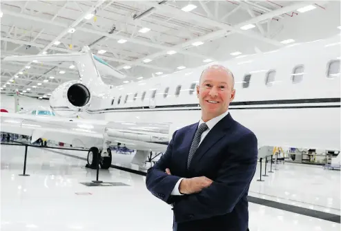  ?? ALLEN MCINNIS / POSTMEDIA NEWS ?? Bombardier CEO Alain Bellemare stands in front of a Global business jet. Bombardier will use $372 million from the government to support the production of its C Series and Global 7000 jets.