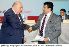  ??  ?? WFPMA Secretary General Bob Morton and CIPM Sri Lanka President and APFHRM Director Dhammika Fernando exchange the agreement