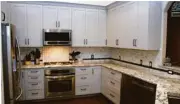  ?? Photo courtesy of My Cabinet Source ?? Gray cabinets were used in a Pearland kitchen by My Cabinet Source.