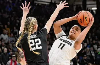  ?? Cliff Grassmick/associated Press ?? Colorado forward Quay Miller shoots over Stanford forward Cameron Brink in the first half of the Buffaloes’ 71-59 win on Sunday in Boulder, Colo.