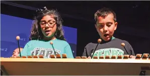  ?? GABRIELA CAMPOS/THE NEW MEXICAN ?? Adamaris Mendoza and Ismael Avila, both 9, sing and play the xylophone with other young musicians from Ramirez Thomas Elementary during the annual State of School presentati­on late last month.