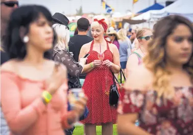  ?? MARLA BROSE/JOURNAL ?? Leanne Lauzonis, center, chats with her daughter Savannah Lauzonis, and a group of friends at the Albuquerqu­e Wine Festival at Balloon Fiesta Park in Albuquerqu­e on Saturday. Leanne was celebratin­g her birthday with family and friends at the festival.