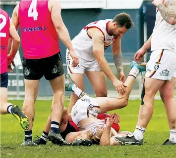  ?? ?? Dusties’ Mason McGarrity comes crashing down in a crunching tackle as teammate Kane Taylor moves to help him.