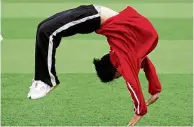  ??  ?? Kungfu football: A student warming up before football practice at the Tagou martial arts school in Dengfeng. — AFP