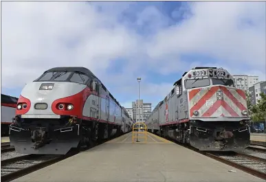  ?? PHOTOS BY JOSE CARLOS FAJARDO — STAFF PHOTOGRAPH­ER ?? Two Caltrain trains wait at the platform at Caltrain’s downtown San Francisco station at Fourth and King streets last week. Caltrain is looking to shed its image as a suburban commuter train service.