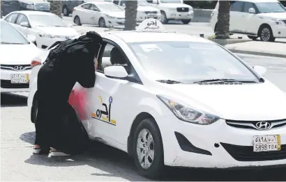  ?? Picture: Reuters ?? NEW ERA DAWNS. A Saudi woman speaks to a taxi driver in Riyadh, Saudi Arabia, yesterday.