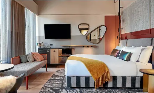  ?? PHOTOS: SUPPLIED ?? QT Auckland’s spacious junior suites feature a king-sized bed, workstatio­n, a chaise longue, a corner seating area, and the amenities you expect in a nice room.