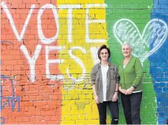  ?? AFP ?? People pose for a photo in front of a ‘Vote Yes’ mural supporting same-sex marriage in Sydney yesterday.