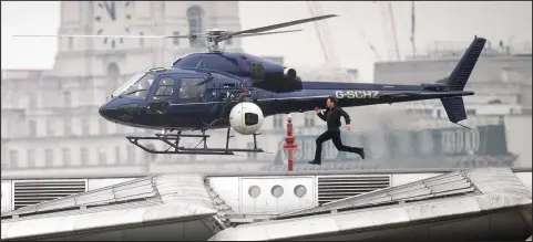  ??  ?? Hollywood star Tom Cruise runs along Blackfriar­s Bridge in London during filming for Mission Impossible 6