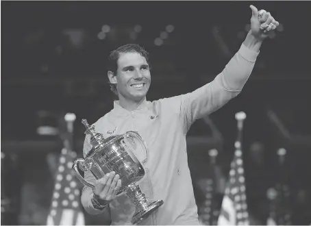  ?? CHRIS TROTMAN/GETTY IMAGES FOR USTA ?? Rafael Nadal poses with the championsh­ip trophy after winning the U.S. Open in New York on Sunday.