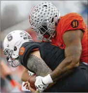  ?? JONATHAN BACHMAN / GETTY IMAGES ?? Kurt Benkert of the South team is sacked by Jalyn Holmes of the North team during the first half of the Reese’s Senior Bowl.