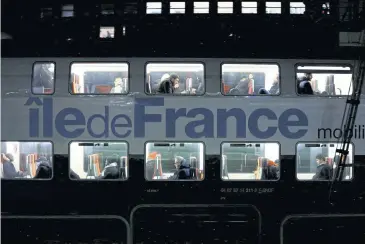  ?? REUTERS ?? Passengers are seen on a suburban train at Montparnas­se station during a strike by French SNCF workers in Paris yesterday.