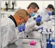  ?? (AP/Marcio Jose Sanchez, Pool) ?? Technician­s conduct coronaviru­s tests Friday at a new $120 million facility in Valencia, Calif. The state is working with corporate partner PerkinElme­r to run the lab, which will be able to process 150,000 tests per day.