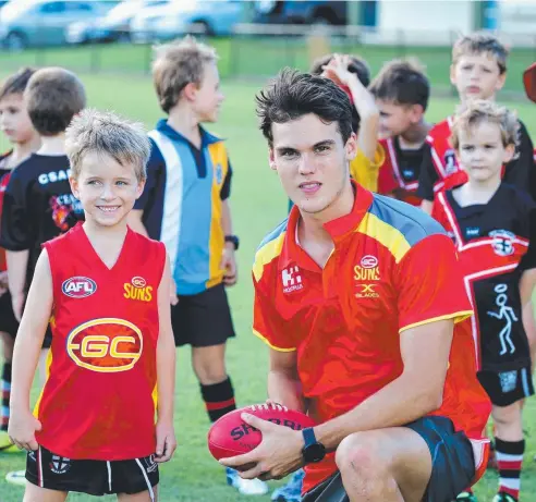  ?? Picture: ANNA ROGERS ?? DEJA VU: Suns player Jack Bowes with Mitchell Moore, 6, from the under-8s at the Australia Post Community Camp.