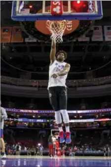  ?? CHRIS SZAGOLA — THE ASSOCIATED PRESS ?? The 76ers’ Joel Embiid goes up for a shot during warmups last week in Philadelph­ia. Embiid will reportedly sign a massive contract extension that eliminates any fear of him becoming a restricted free agent after this season.